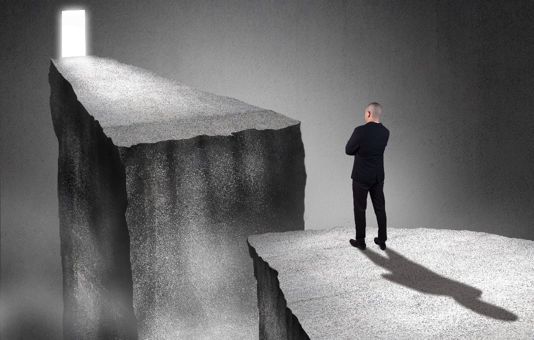 Man needing to get past chasm to opportunity