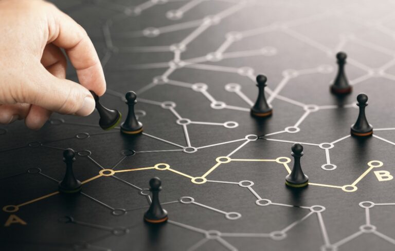 Hand moving chess pieces from point A to point B