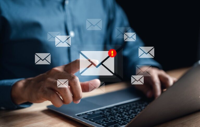 Businessman sending email by laptop