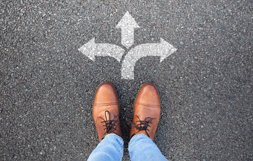 Man standing at the crossroads of a decision