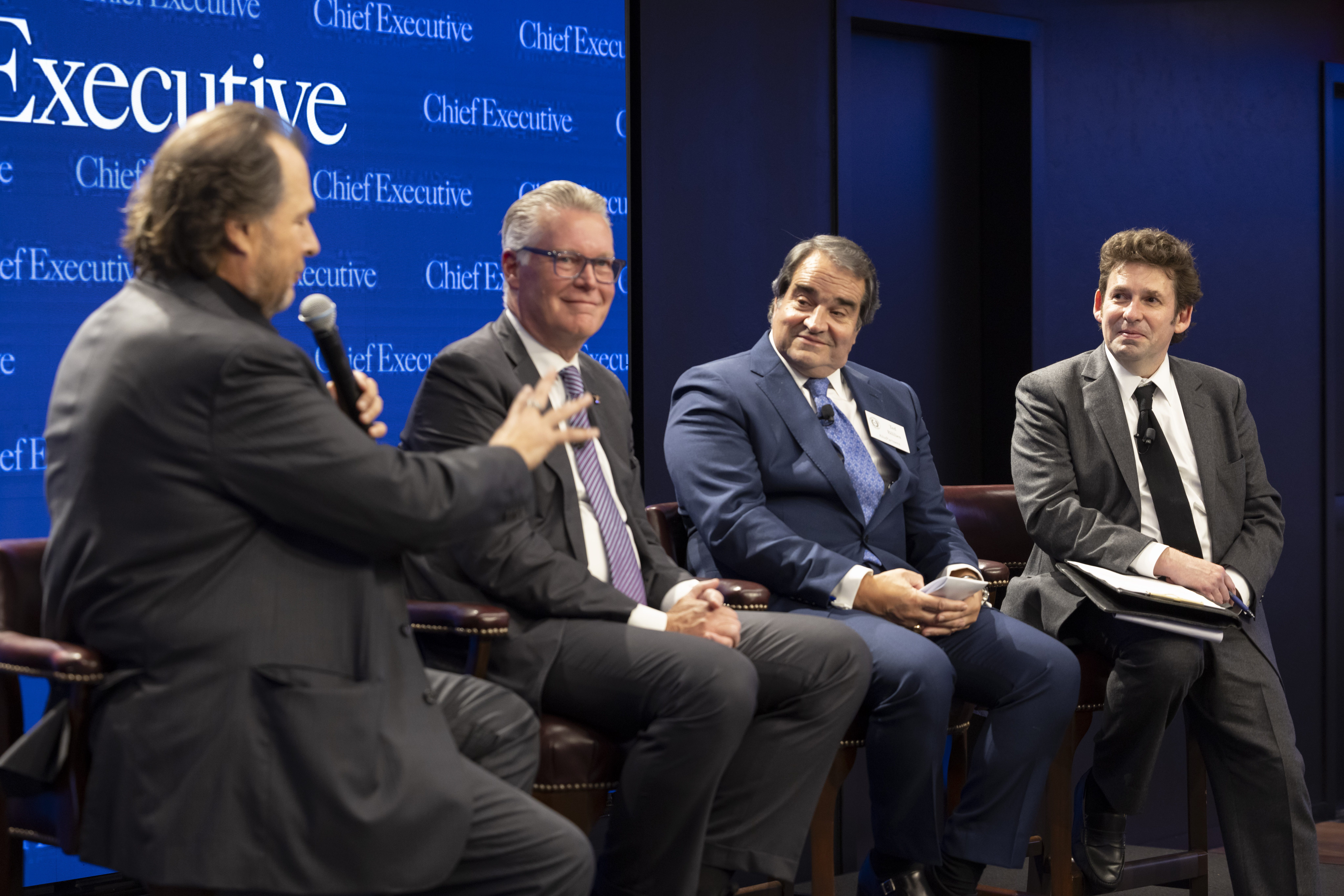 Marc Benioff, Ed Bastian, Ted Bililies and Dan Bigman seated on stage during a panel discussion