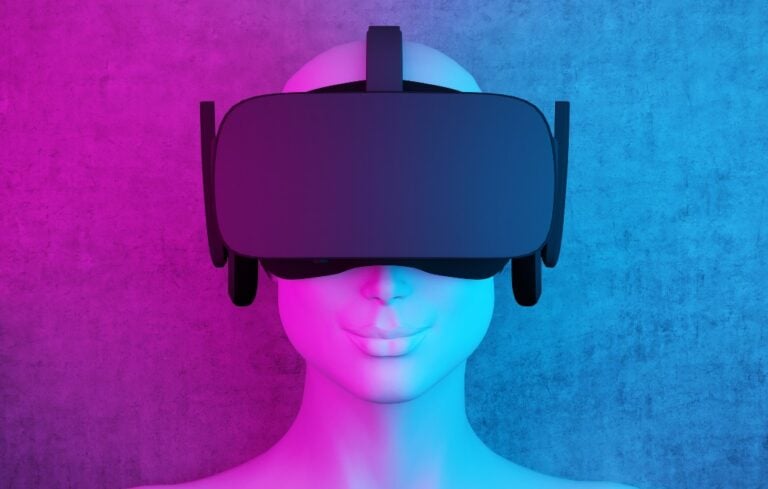 Mannequin head wearing VR headset on purple and blue background